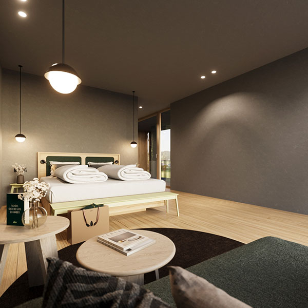Doppelbett mit roter Tagesdecke und Wandbeleuchtung